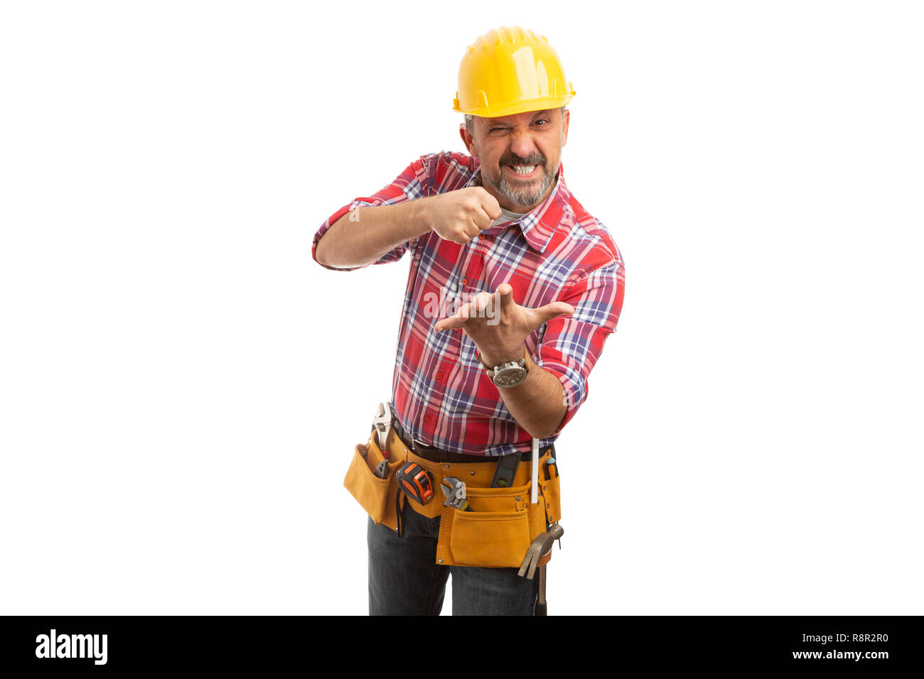 Builder with angry expression smashing invisible object in palm with ...