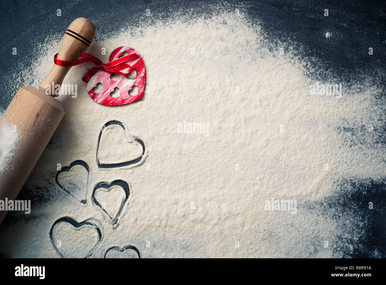 Background for Valentine's Day baking with hearts and flour Stock Photo