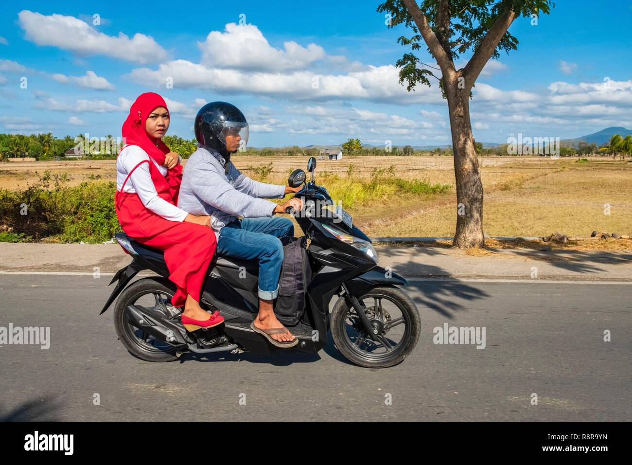 Indonesia, Lombok, Muslim couple on a motorcycle Stock Photo