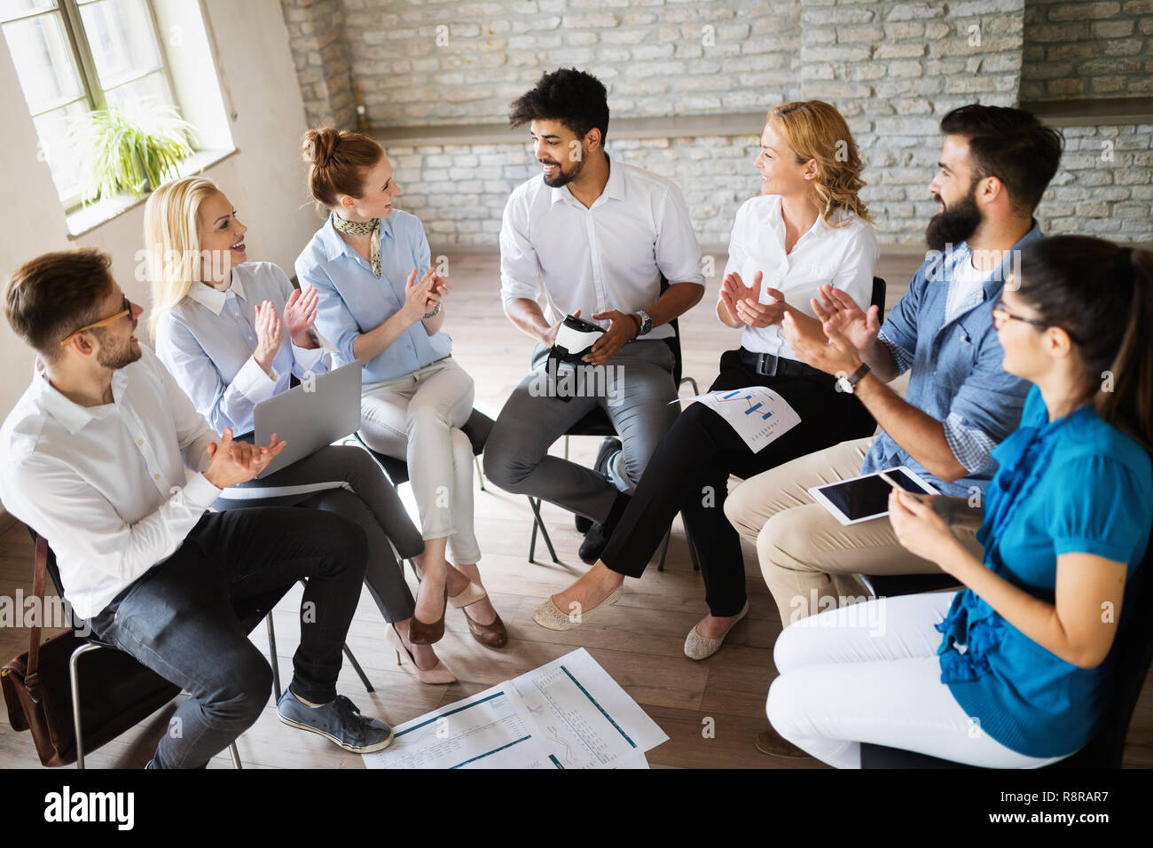 Happy success business team celebrating victory in office Stock Photo ...
