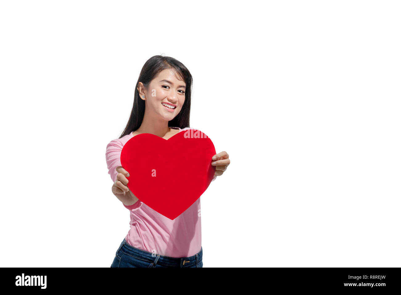 Beautiful asian woman showing red heart shaped standing isolated over ...