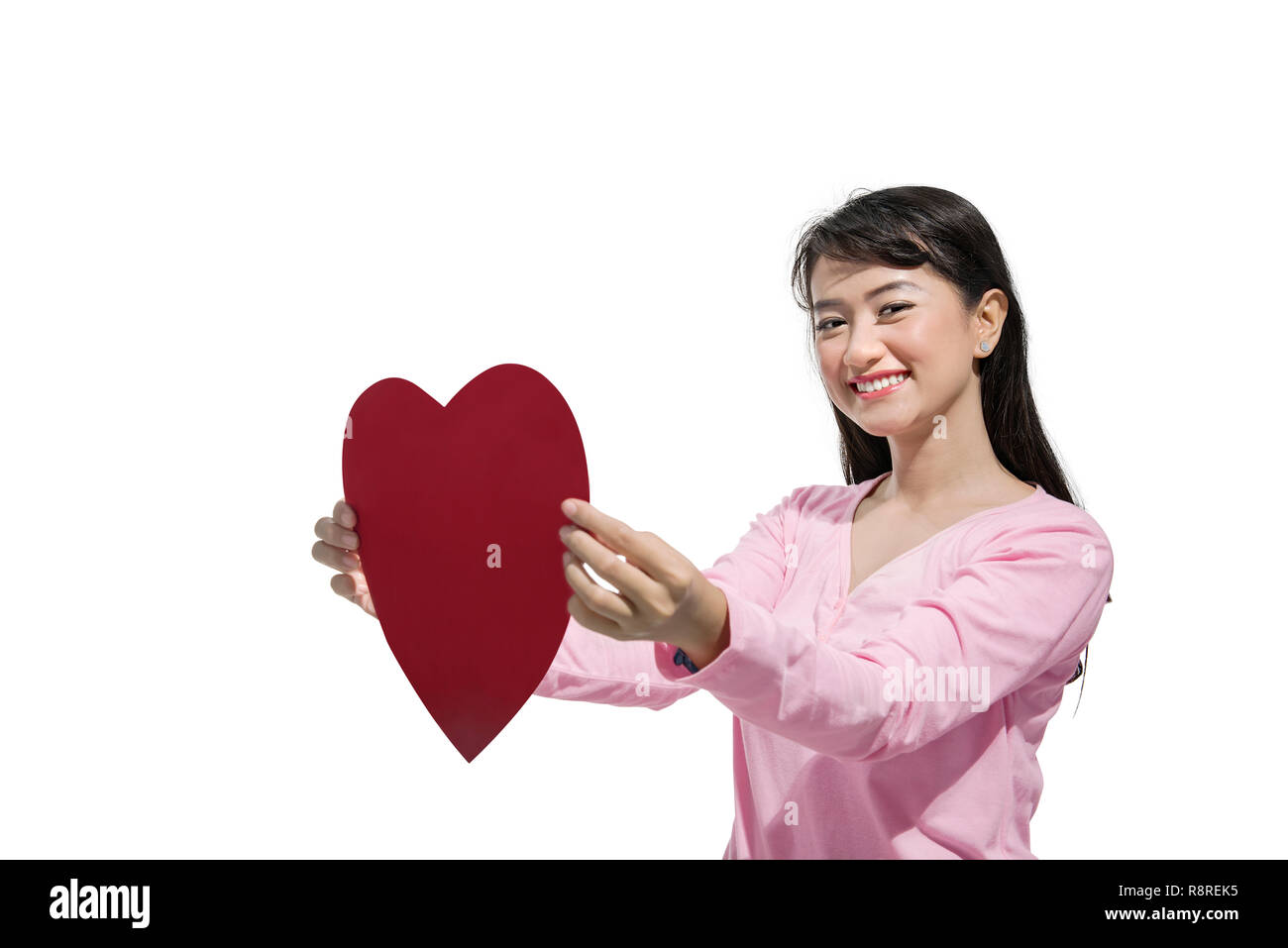 Pretty asian woman holding red heart posing isolated over white ...
