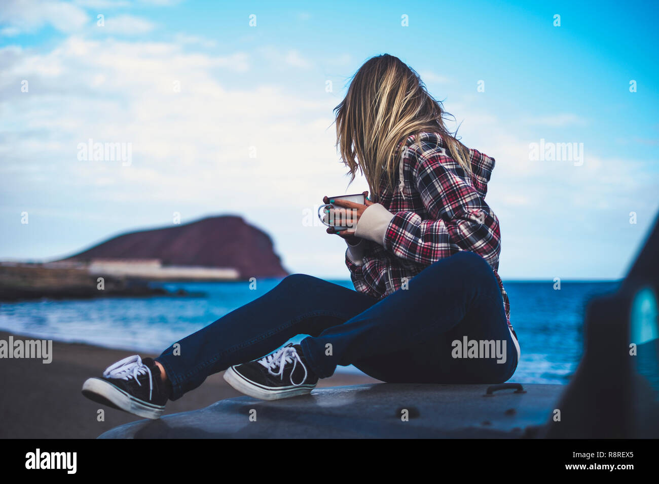 Rear Back View Of Beautiful Blonde Hair Woman Sitting On The Car And Looking At The Horizon With Blue Ocean And Sky In Background Enjoy Life And Tra Stock Photo Alamy