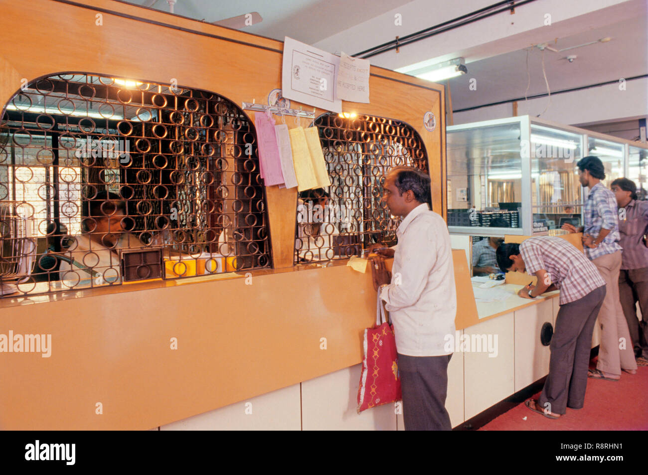 man standing in front of counter, banking industry, Bangalore, Karnataka, India Stock Photo
