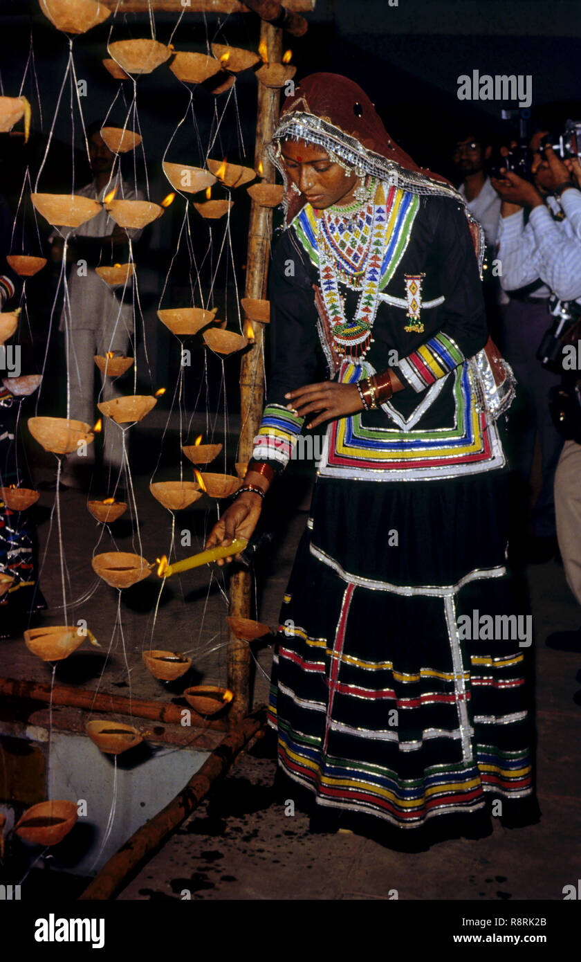 Diwali Festival, adivasi woman lighting diyas, oil lamps, India, Asia Stock Photo
