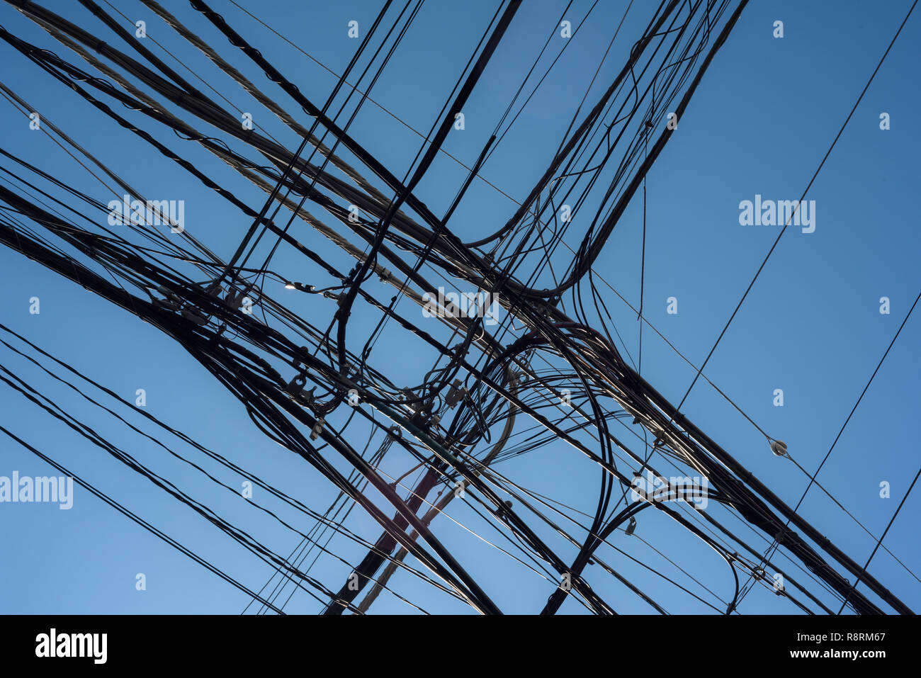 Power lines organized mess and clear blue sky in Tokyo. Stock Photo