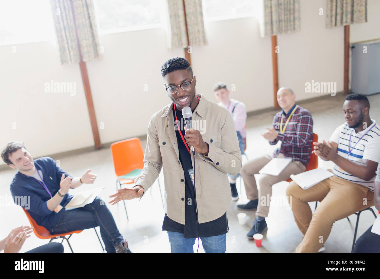 Man holding microphone hi-res stock photography and images - Alamy