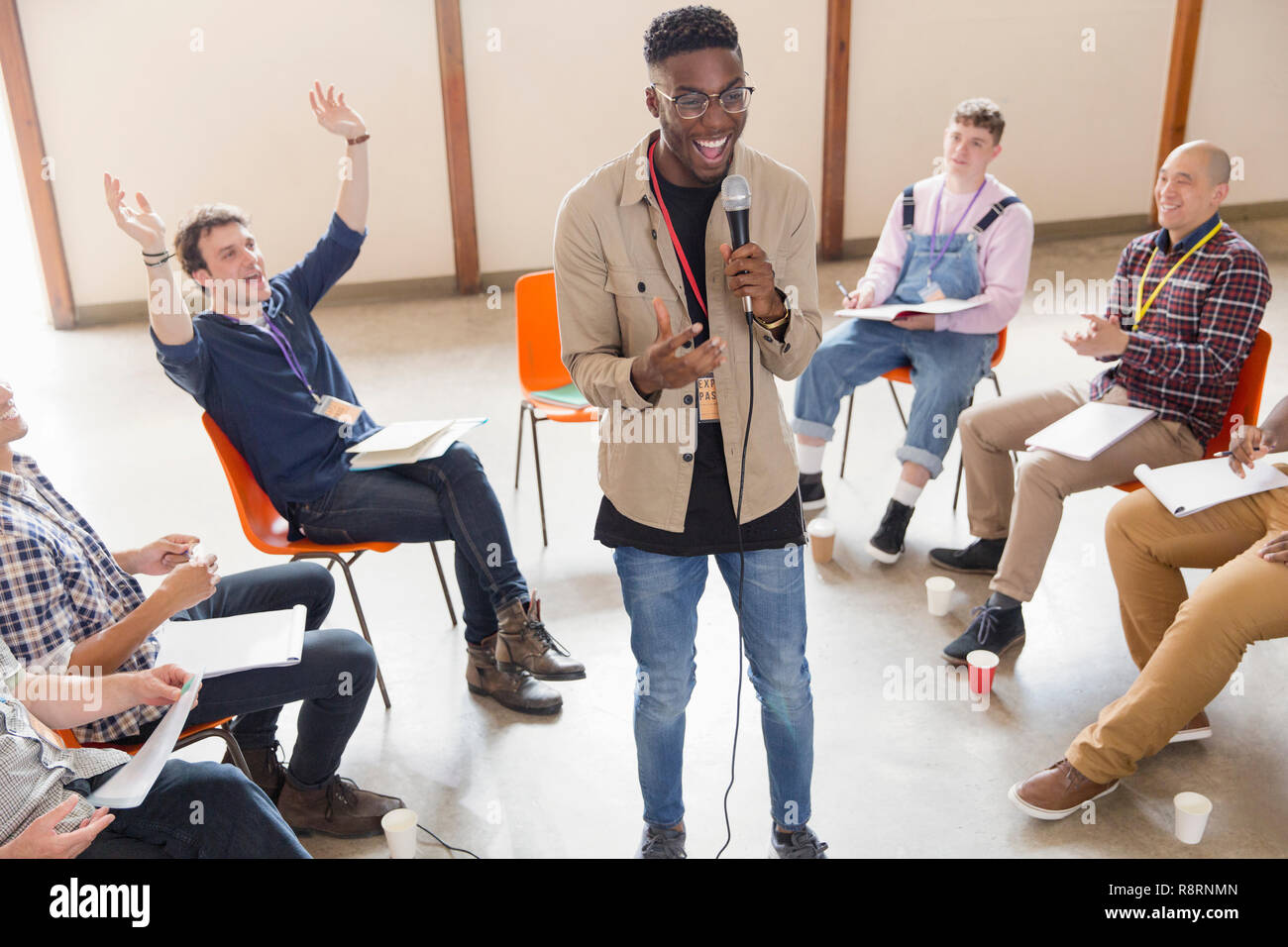 Man with microphone talking, leading group therapy Stock Photo