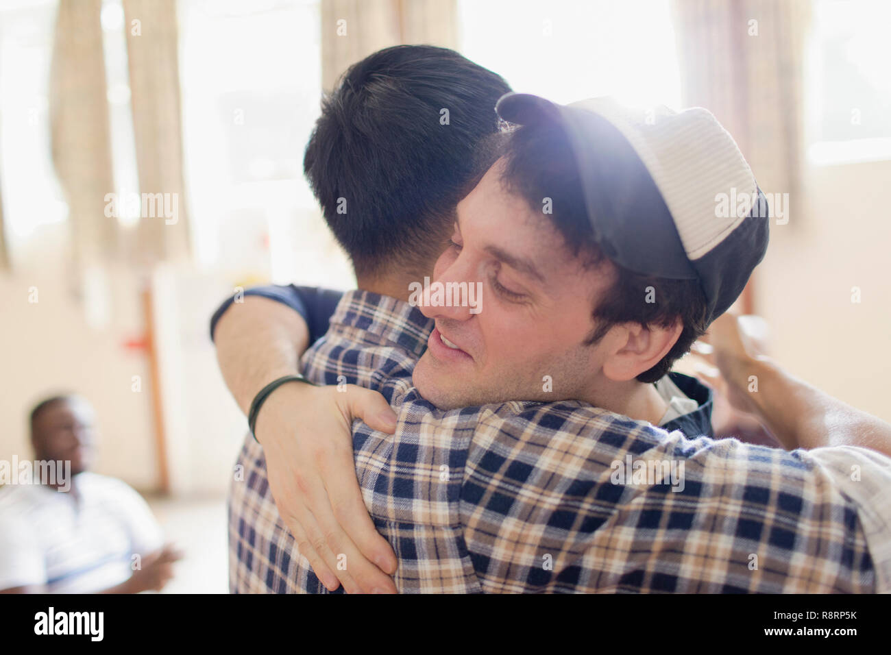 Men hugging Stock Photo