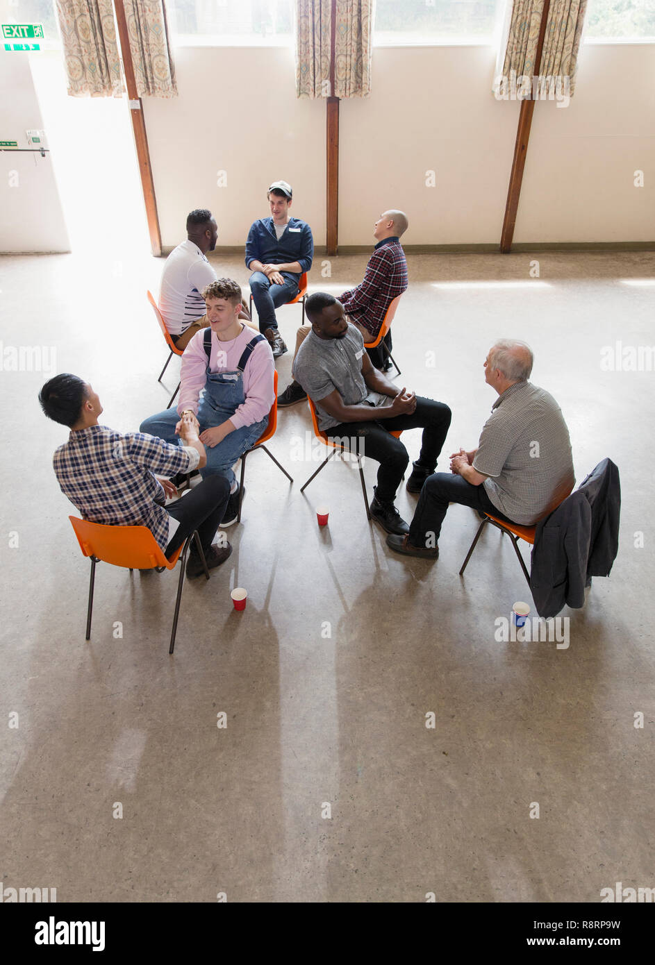 Men talking in group therapy Stock Photo