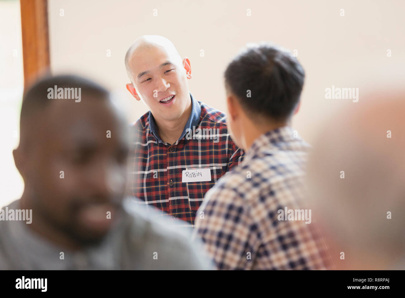 Men talking in group therapy Stock Photo