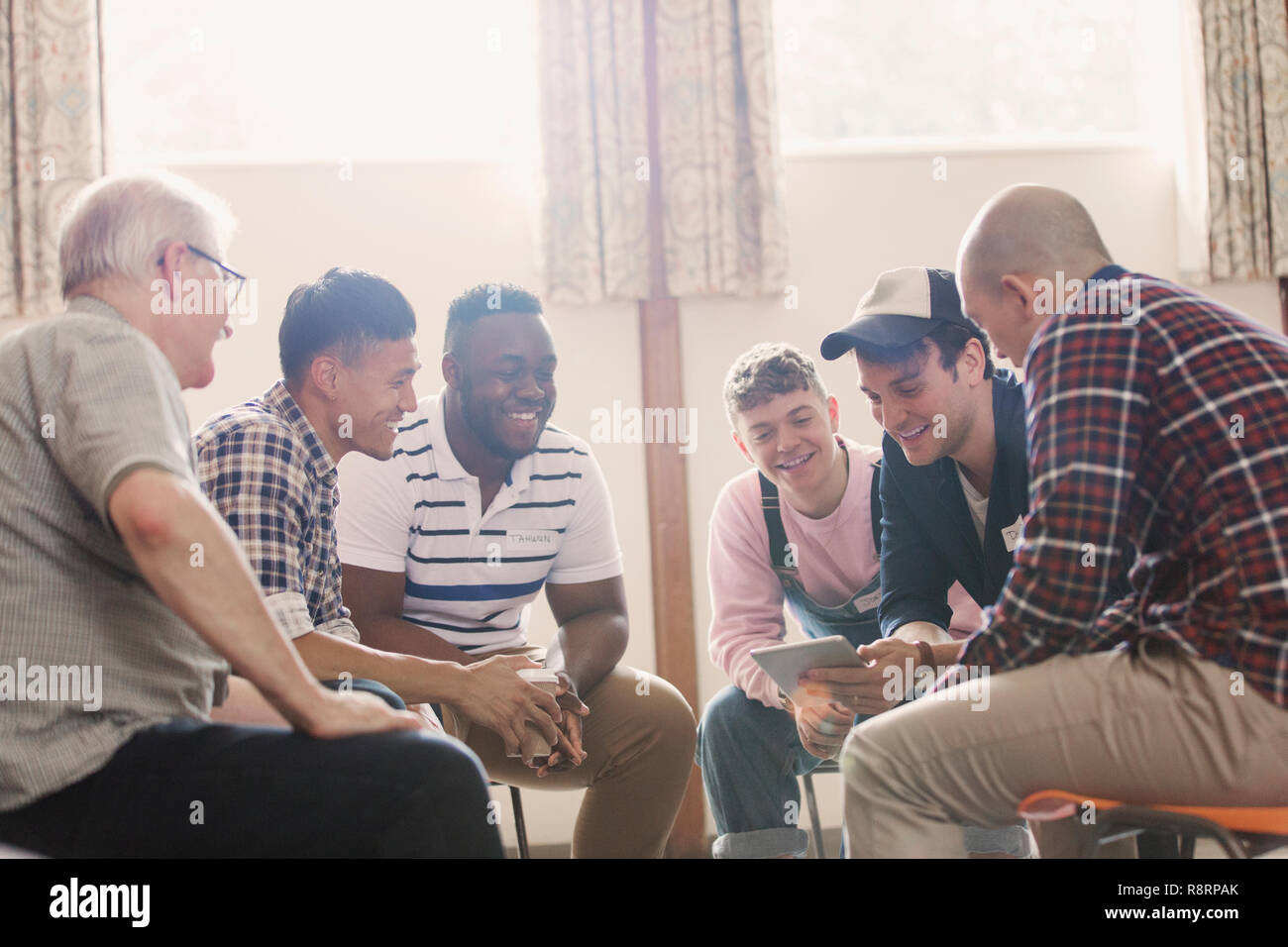 Men talking in group therapy Stock Photo