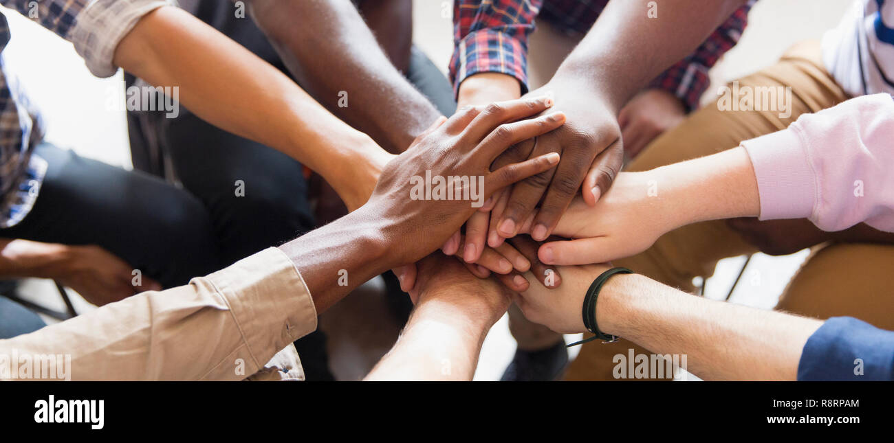 Men joining hands in group therapy Stock Photo