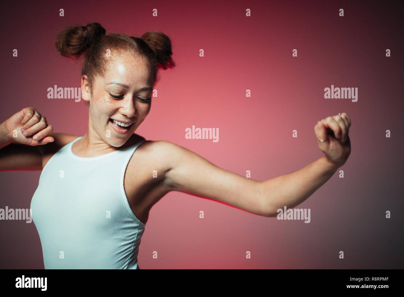Carefree young woman dancing Stock Photo