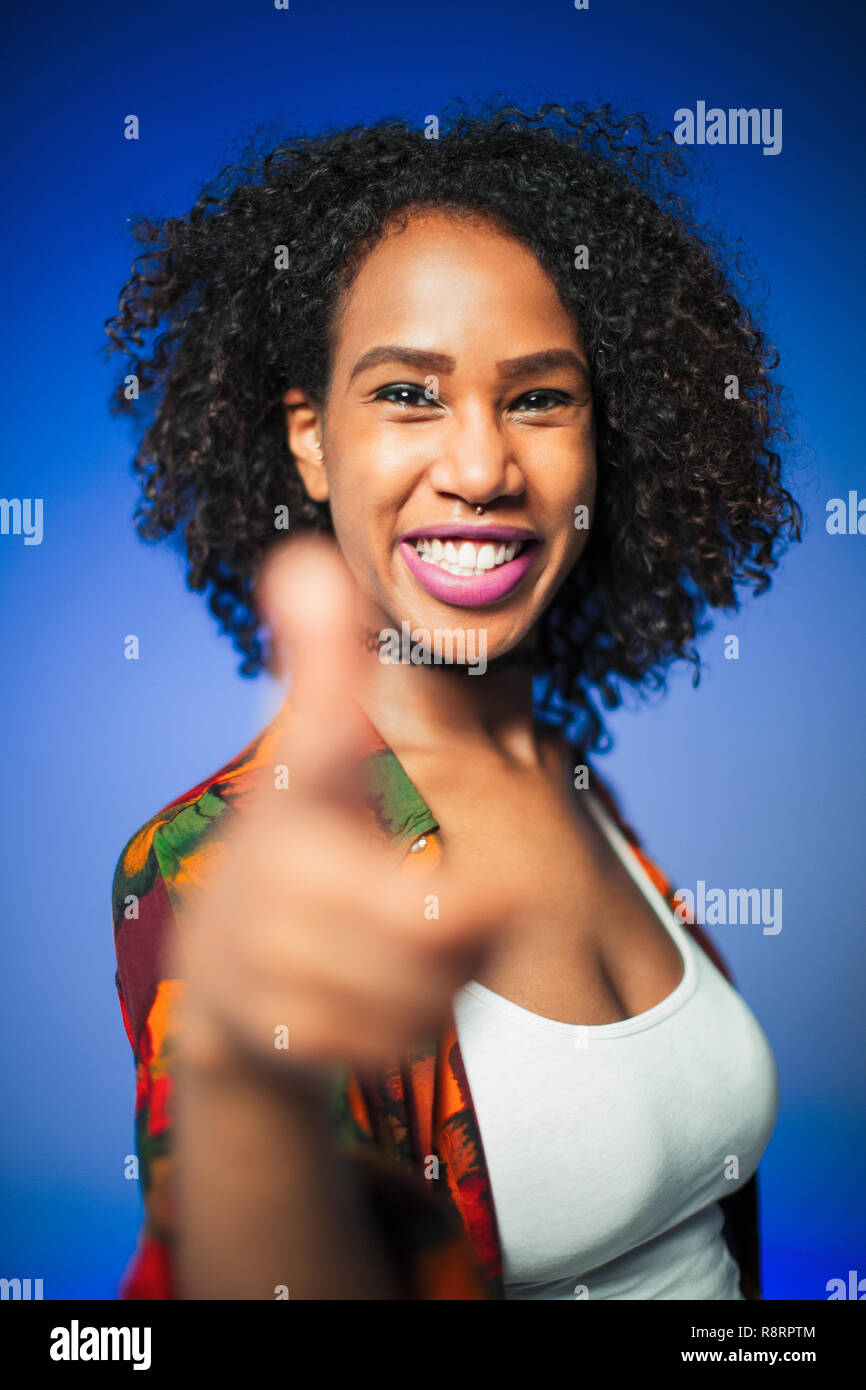 Portrait confident young woman gesturing thumbs-up Stock Photo