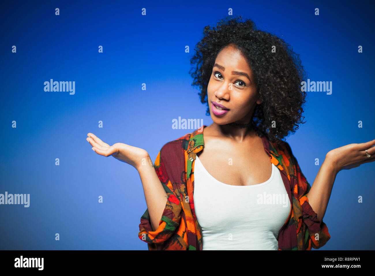 Portrait young woman shrugging Stock Photo