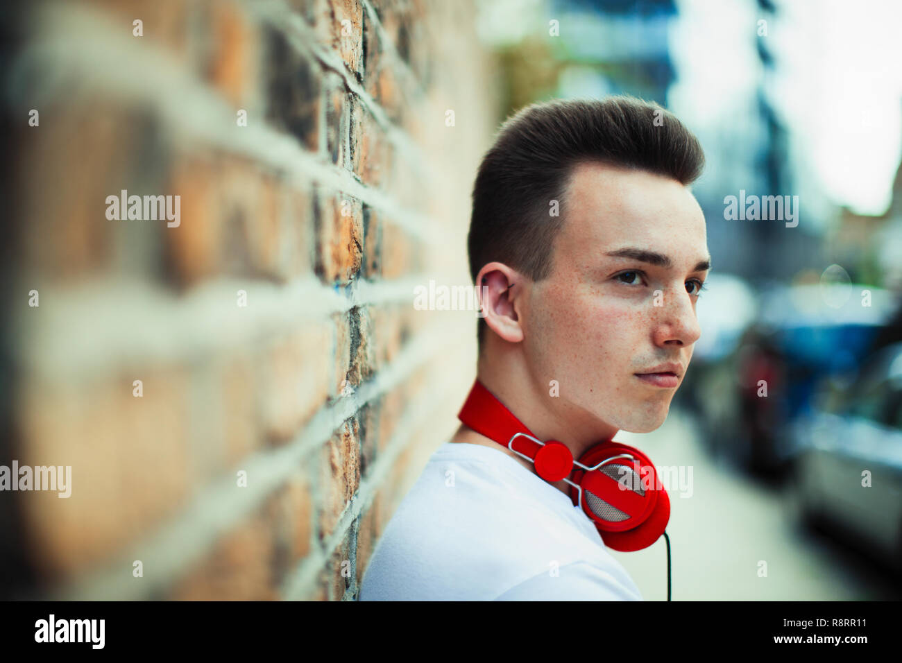 Serious teenage boy with headphones looking away Stock Photo