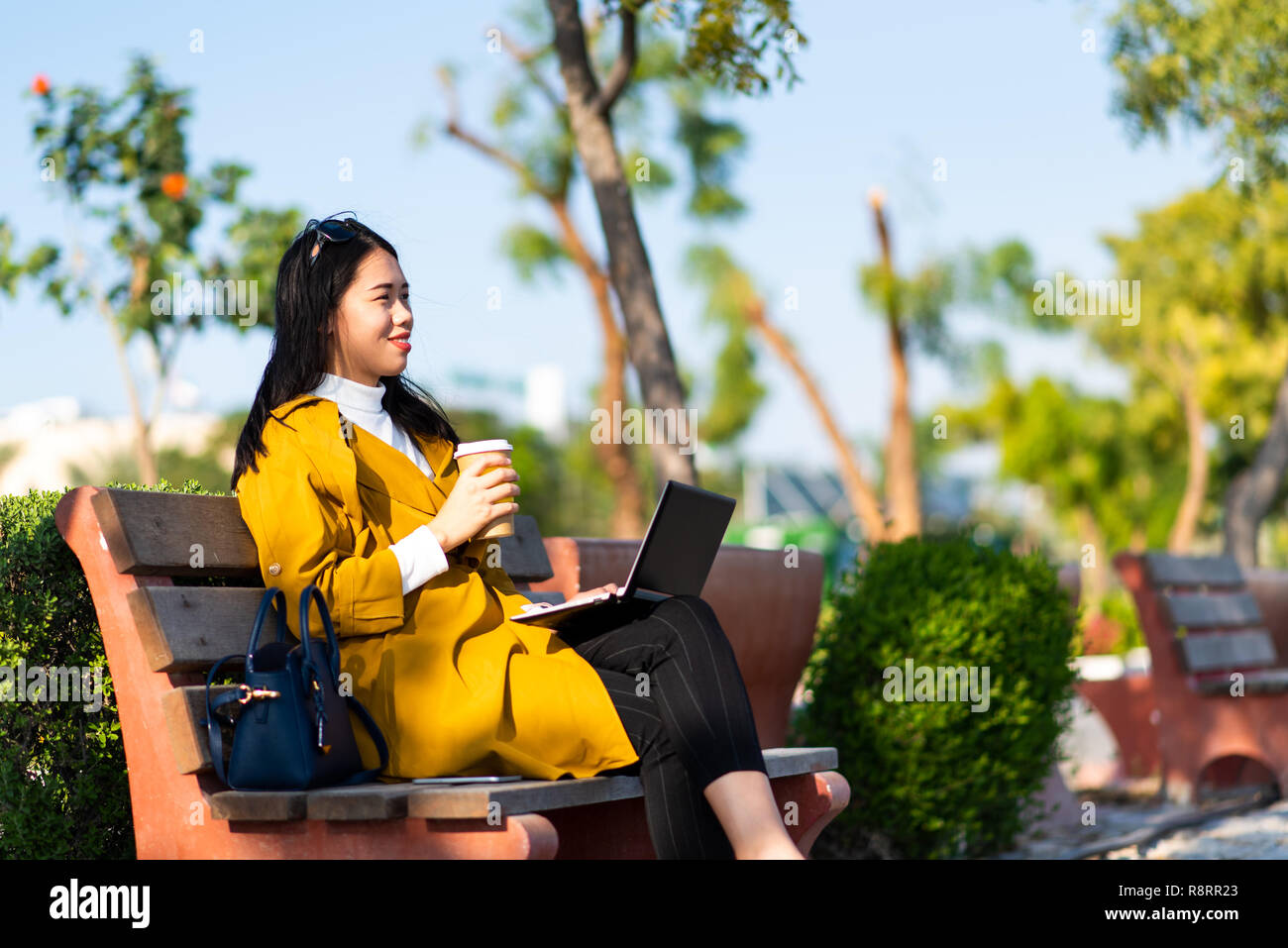 Girl working on laptop outside of the office Stock Photo