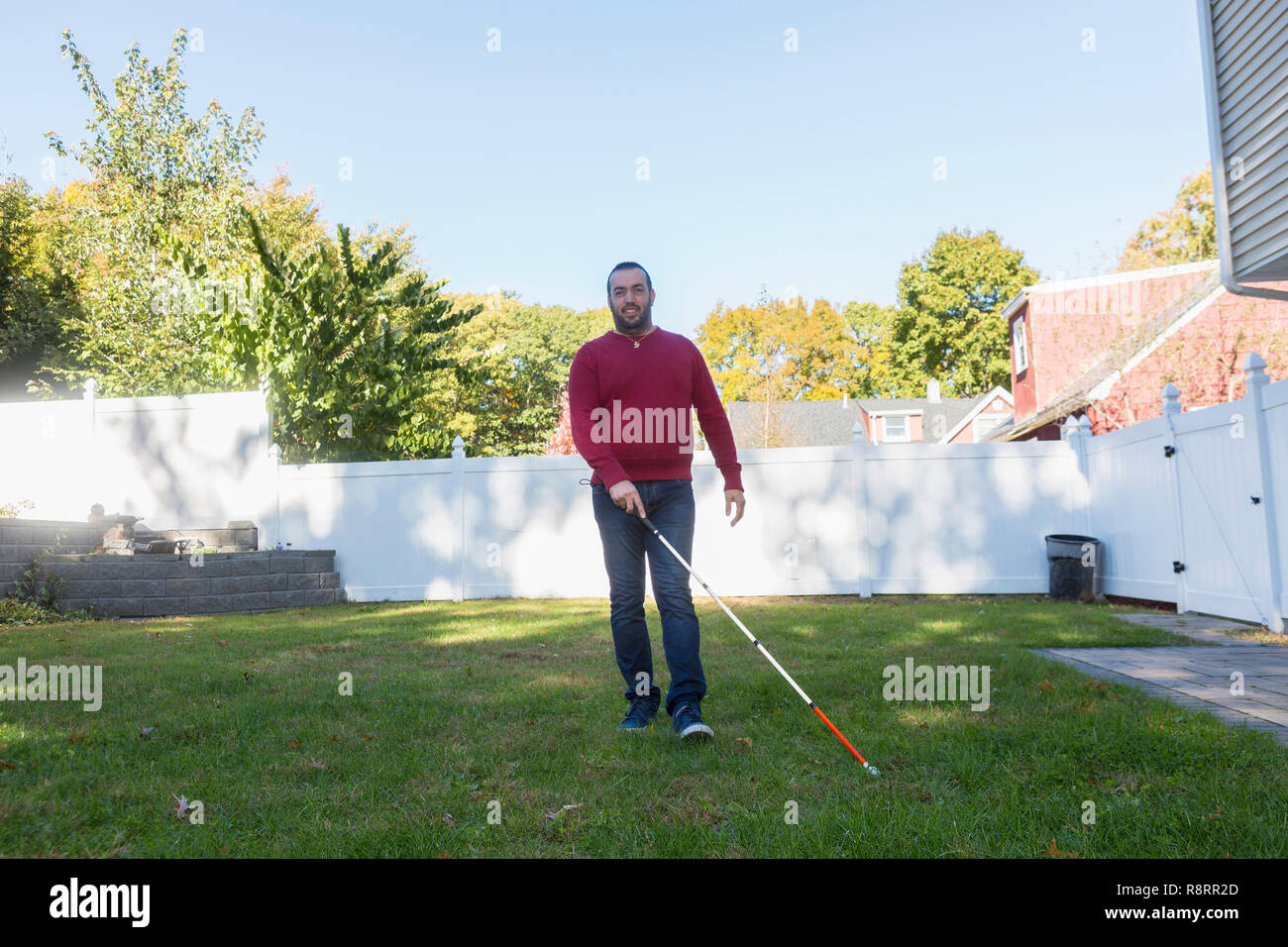 Man with Visual Impairment using his cane outdoors Stock Photo