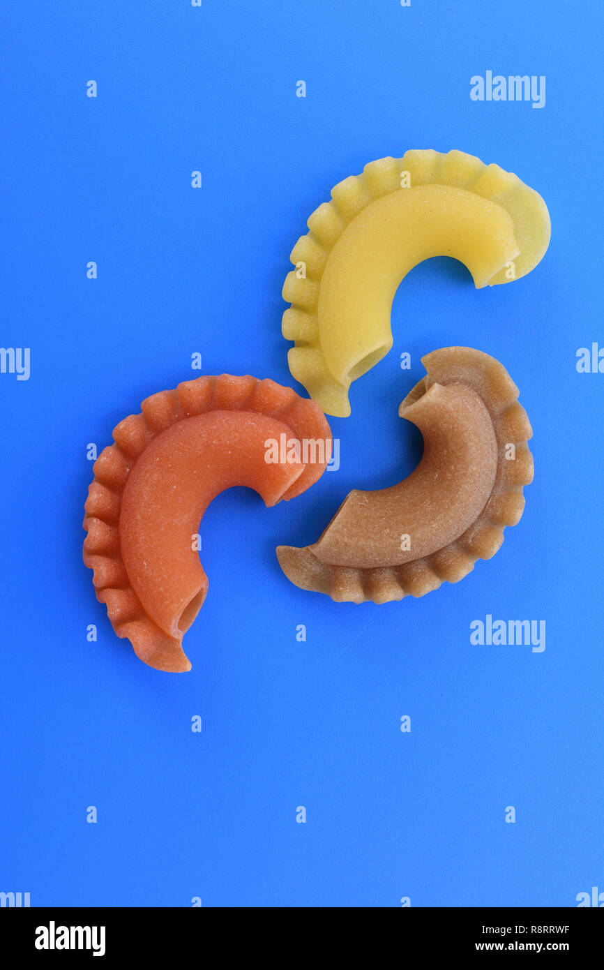 Pasta creste di gallo on blue background Stock Photo - Alamy