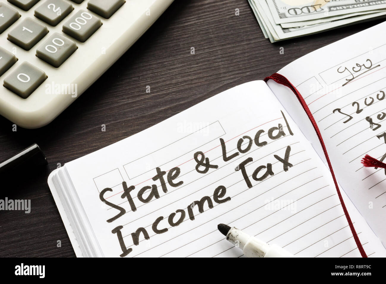 State and local income tax written in a note. Stock Photo