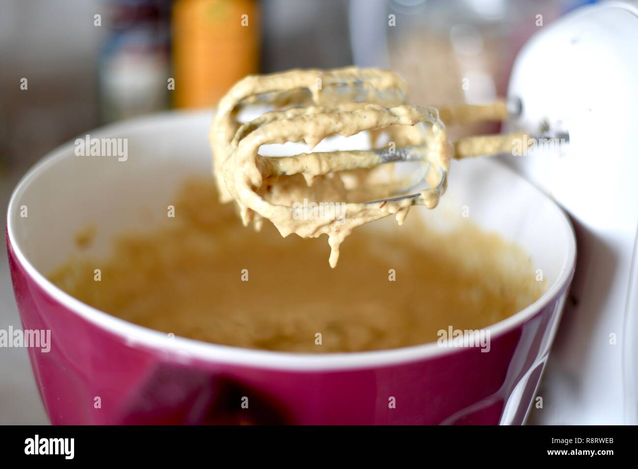 Cake batter mix in bowl and on hand mixer Stock Photo Alamy