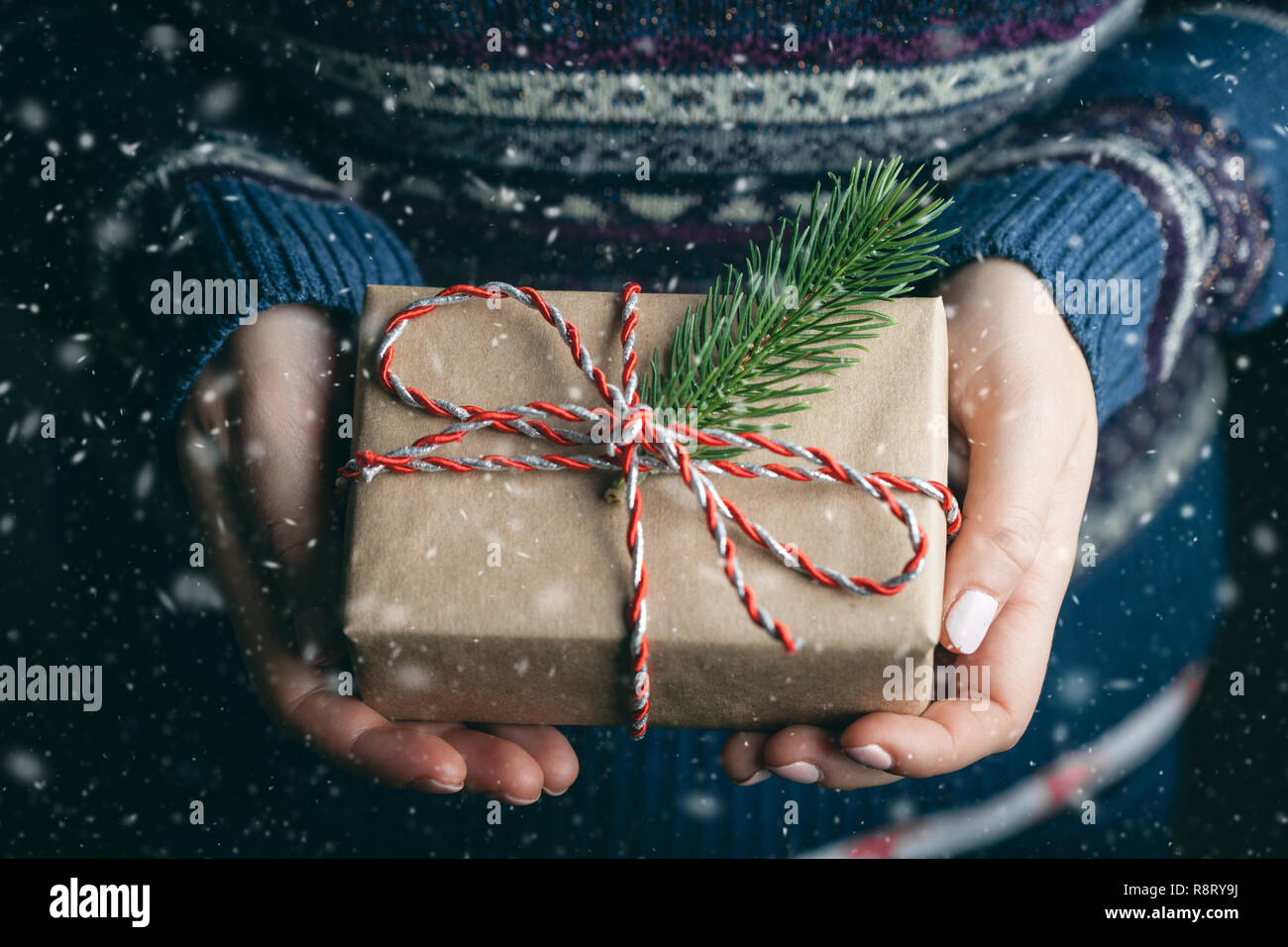 Woman's hands holding little gift. Close up. Stock Photo