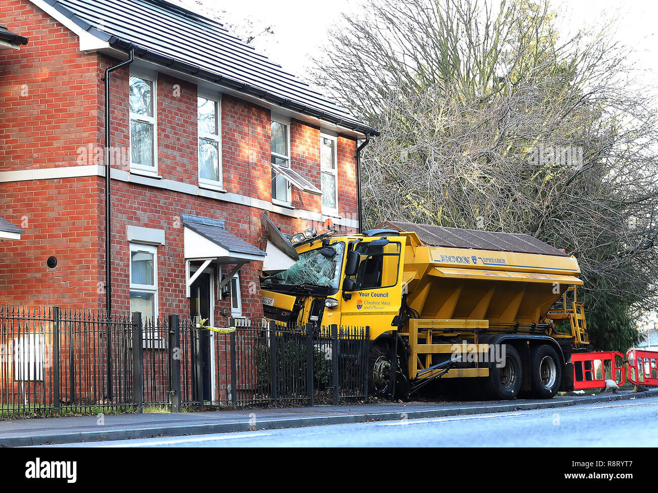 A gritting lorry embedded in a house in Chester Road in Helsby, Cheshire, after it left the road earlier this morning. Stock Photo