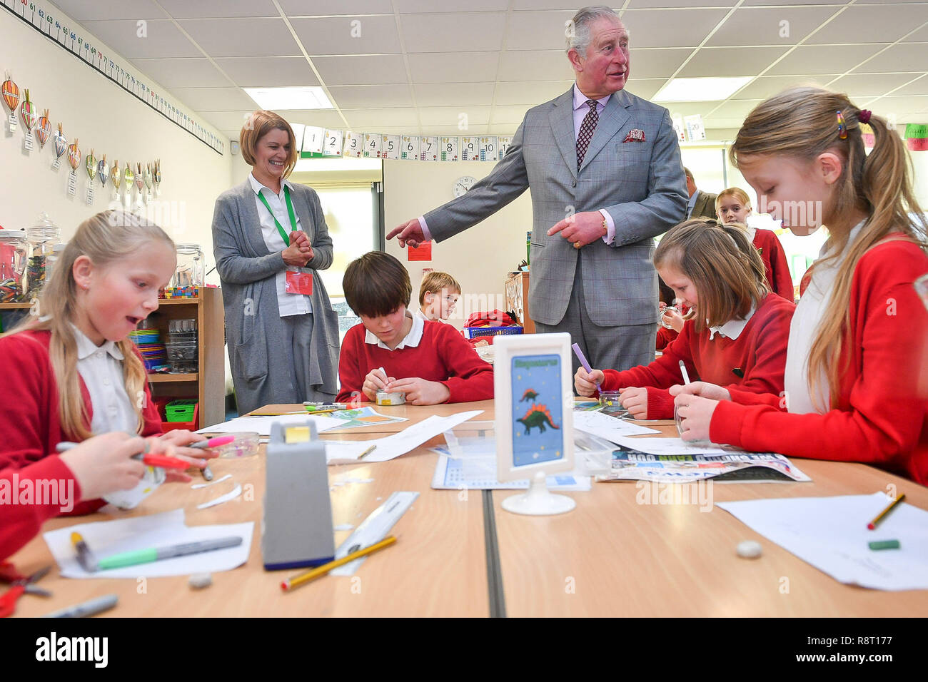 The Prince of Wales watches pupils in year five make Christmas decorations at Leighterton Primary School, Gloucestershire, where he is there to see the new school building and watch pupils take part in a Christmas performance. Stock Photo