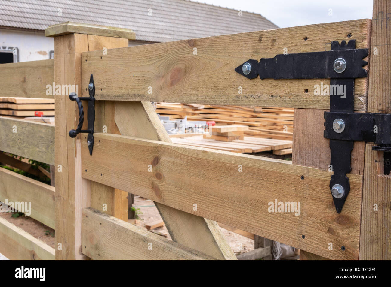 Forged hinges. Forged hinges on the fence ranch style Stock Photo - Alamy