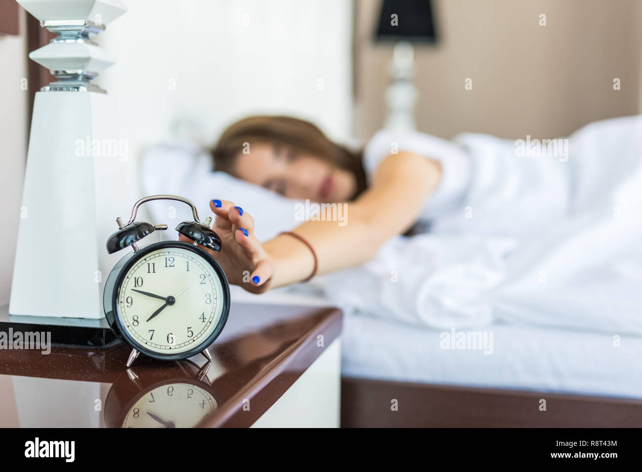 Young Woman Turn Off Alarm Clock In Good Morning Wake Up For Sleep With Closeup Foreground Alarm Clock Relax And Lifestyle Concept Young Woman Turn Off Alarm Clock In Good Morning Wake Up For Sleep With Closeup Foreground Alarm Clock Relax And Lifestyle Concept