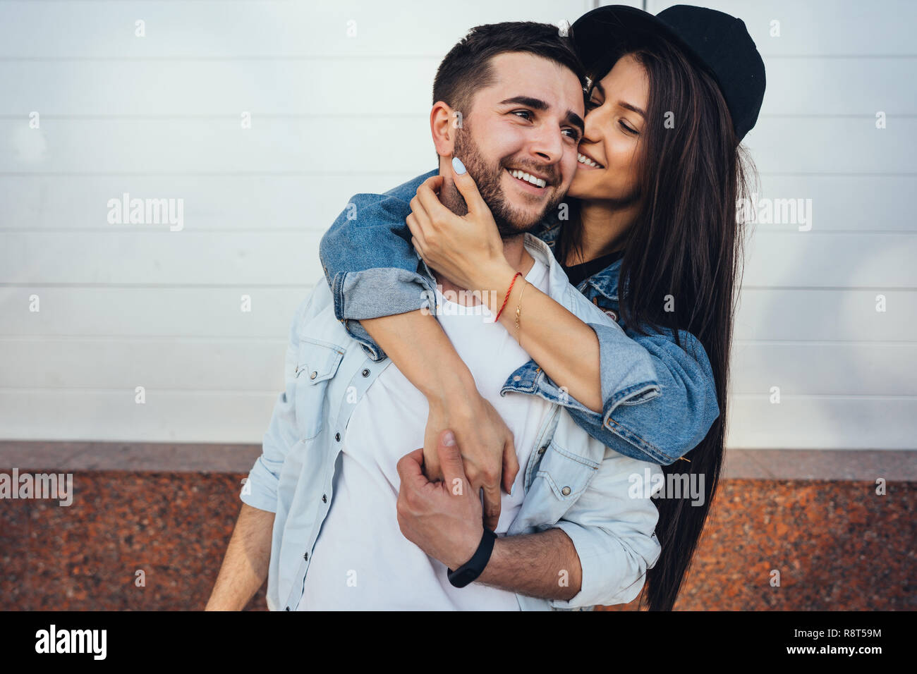 Young beautiful girl hugging her handsome boyfriend Stock Photo - Alamy