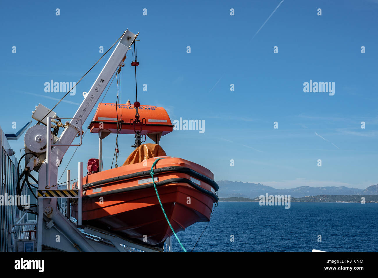 Red rescue boat Lifeboat stands on deck of a ferry Stock Photo