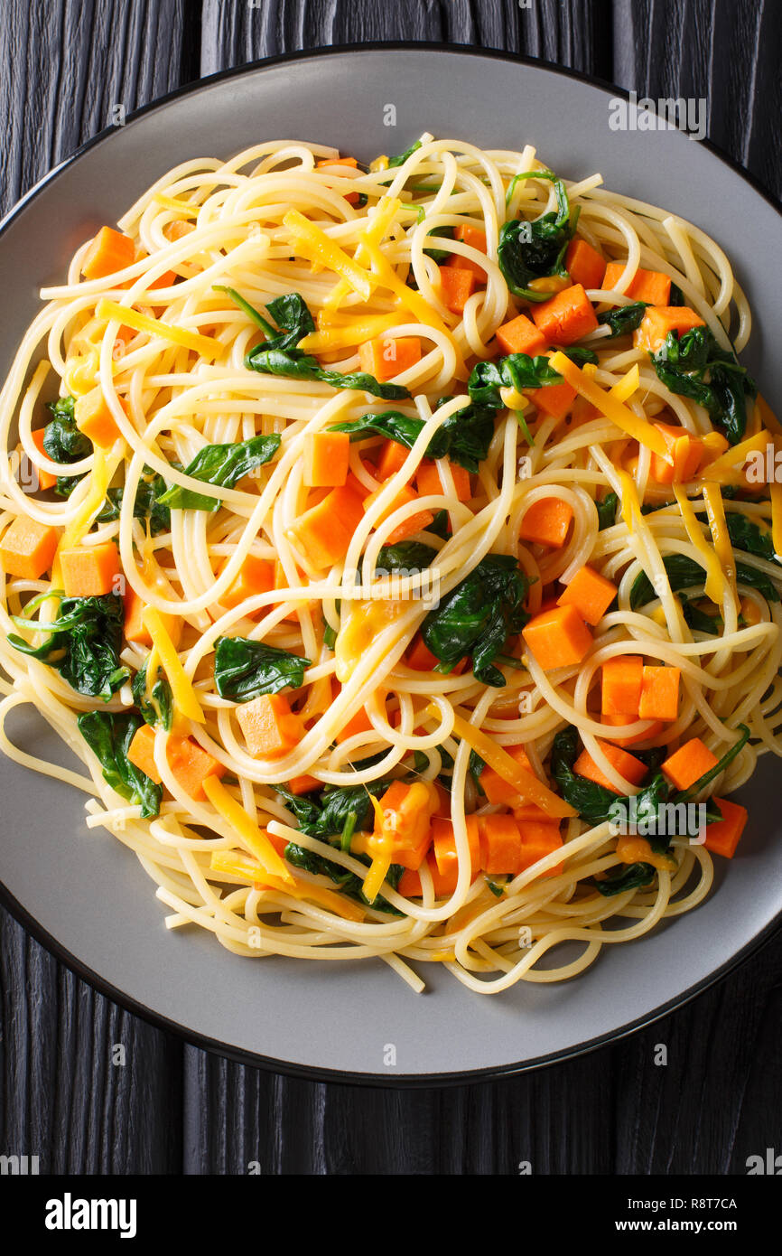 Lowcalorie lunch of spaghetti with pumpkin, spinach and cheddar cheese