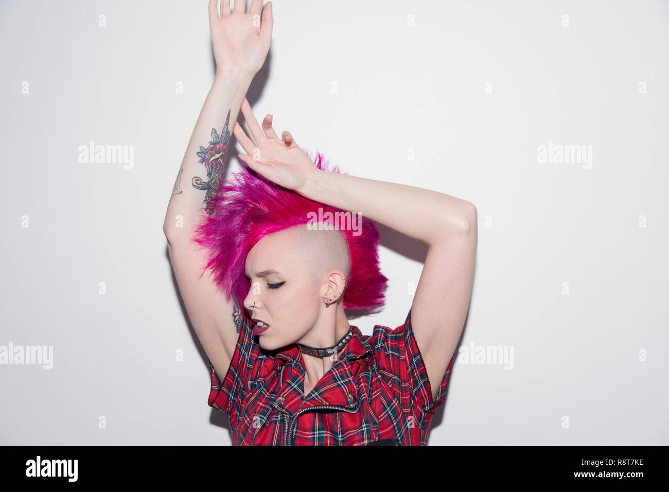 Portrait Confident Young Woman With Pink Mohawk Dancing
