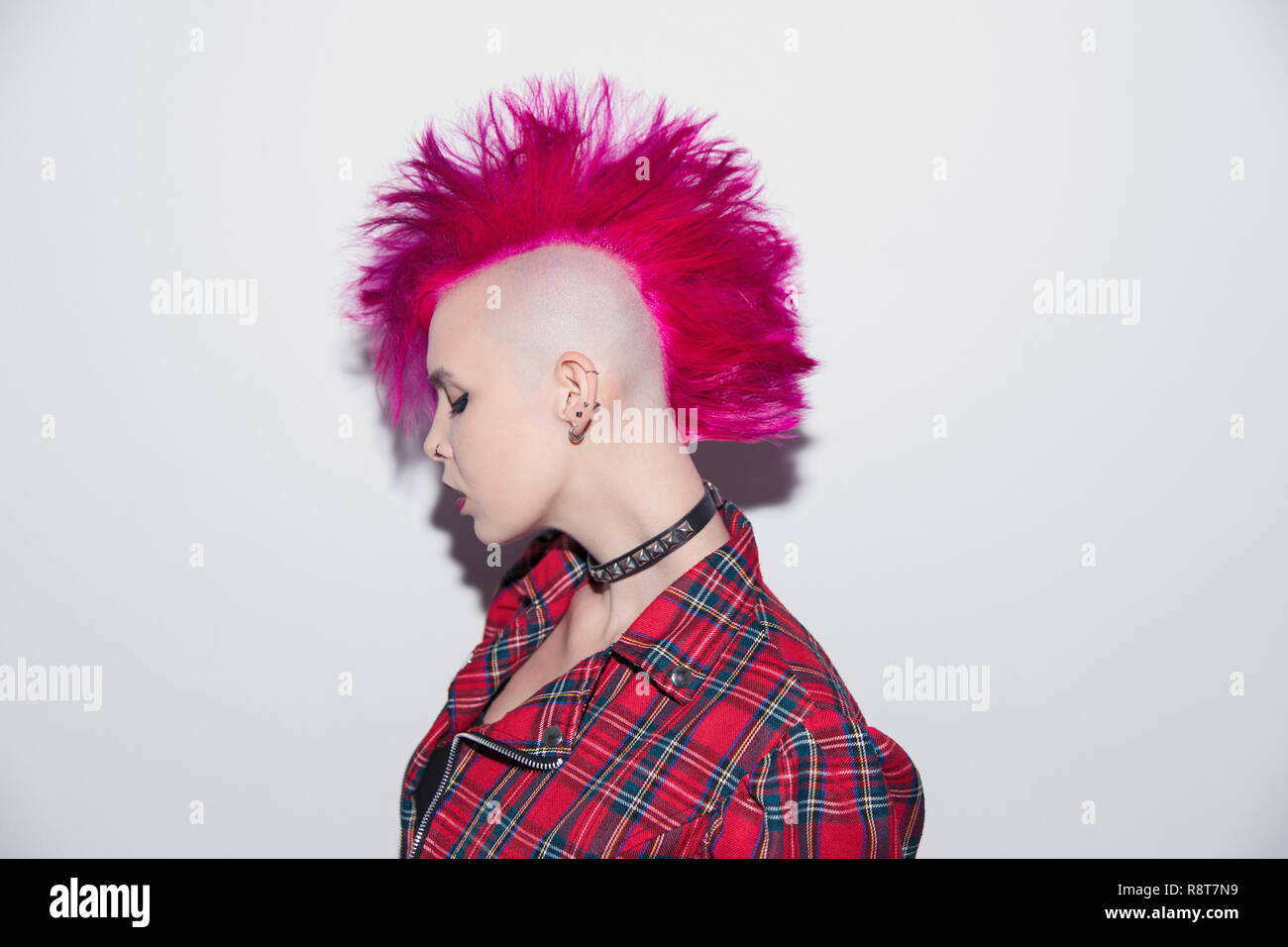Portrait confident young woman with pink mohawk Stock Photo