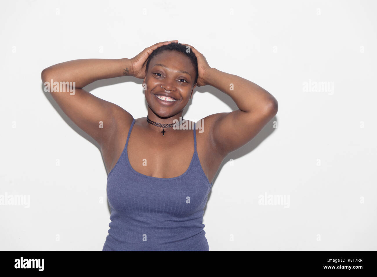 Portrait confident, carefree woman with hands behind head Stock Photo