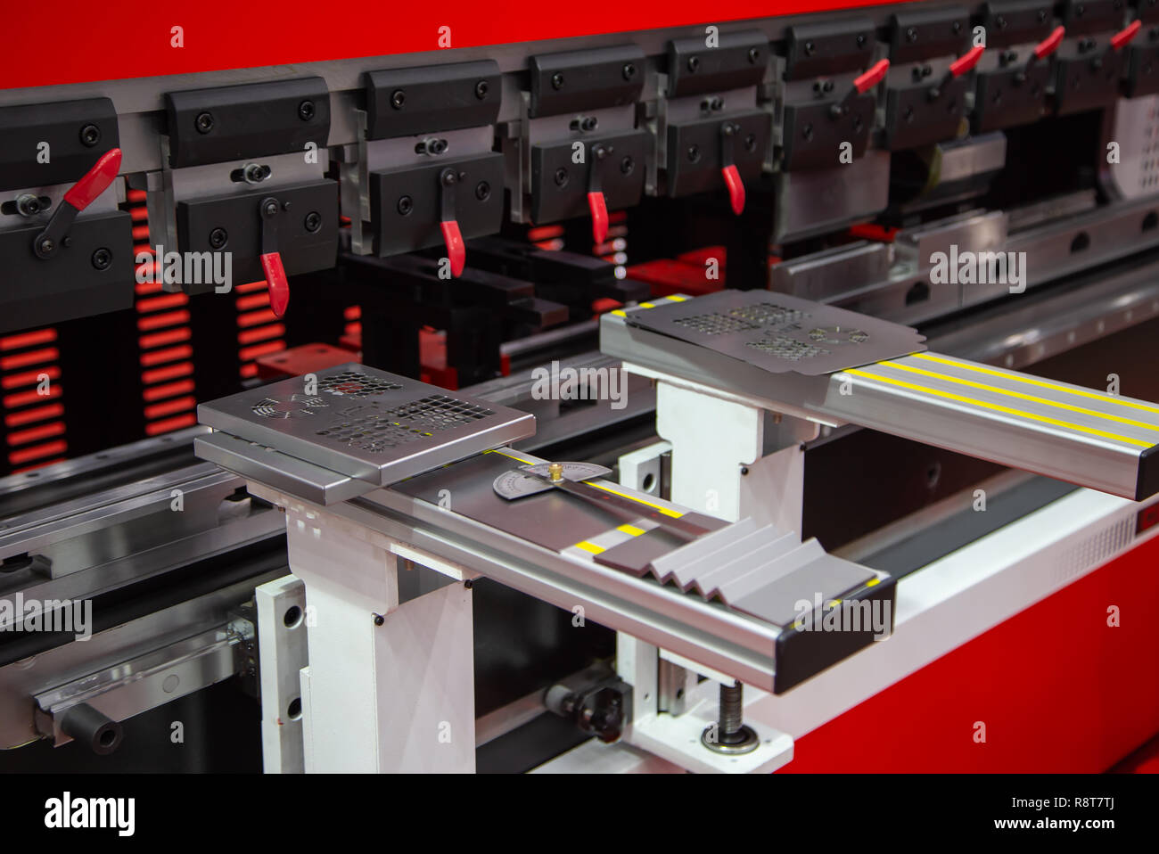 Metal sheet slotting machine cutting stainless steel sheets Stock Photo