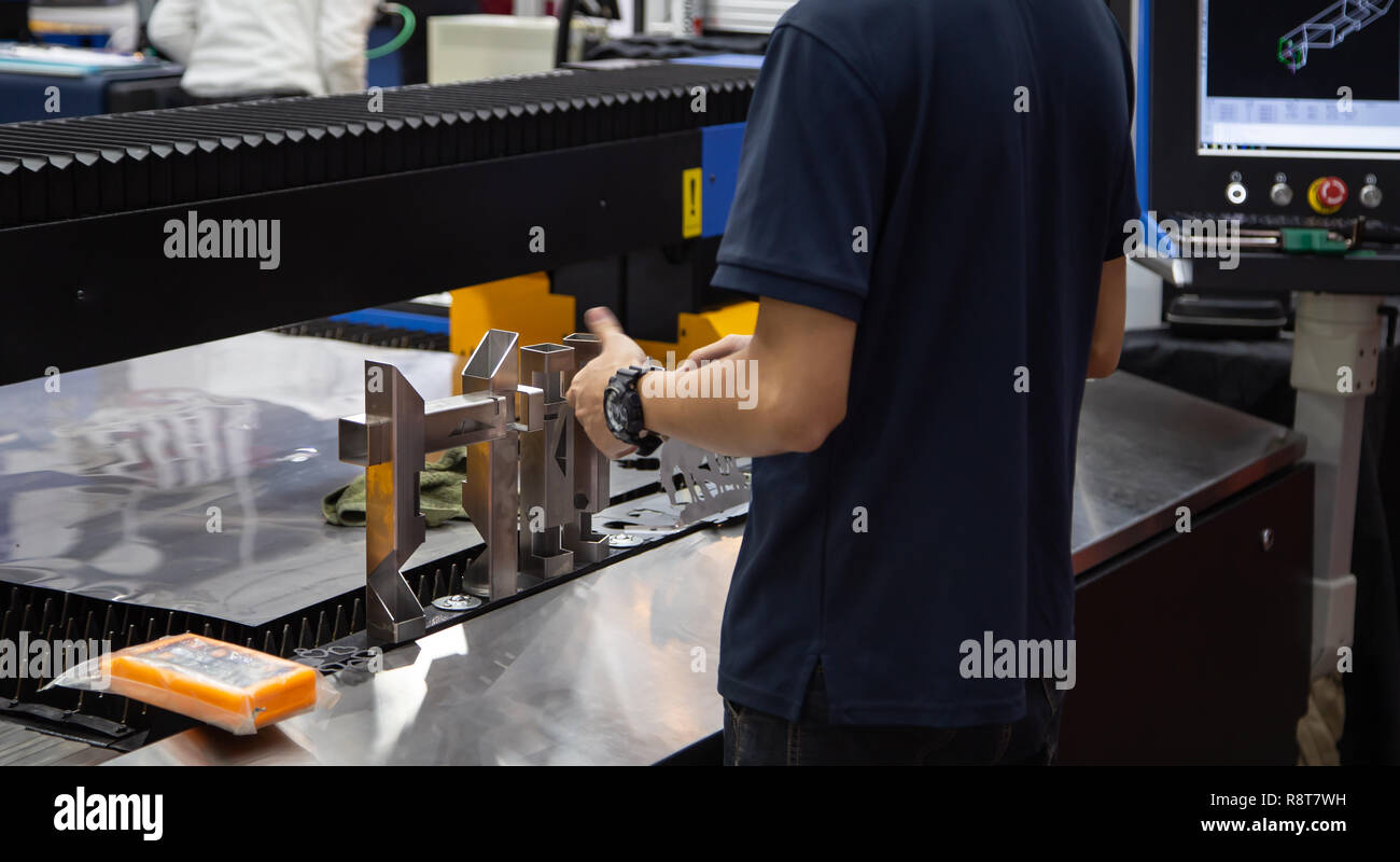 Worker operate CNC laser cutting machine cutting tube Stock Photo Alamy