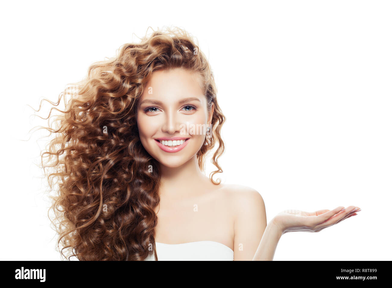 Cheerful woman with long curly hair, clear skin and empty open hand isolated on white background Stock Photo - Alamy Cheerful woman with long curly hair, clear skin and empty open hand isolated on white background Stock Photo - Alamy