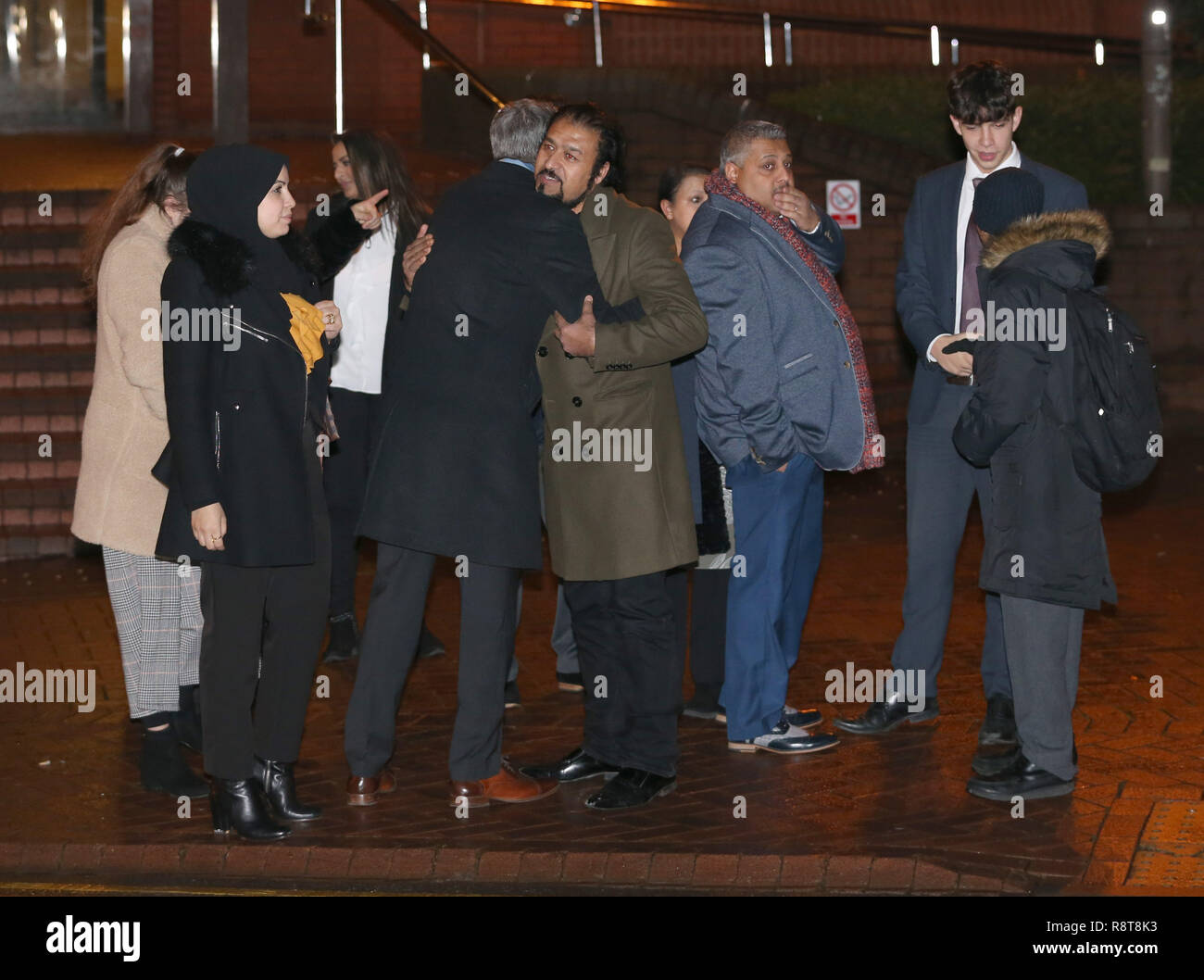 The victims' family embrace outside Birmingham Crown Court after Janbaz Tarin was sentenced to life with a minimum term of 32 years at Birmingham Crown Court after admitting the double murder of his wife, Raneem Oudeh, and her mother, Khaola Saleem, in a frenzied knife attack in Solihull on the 27th August this year. Stock Photo