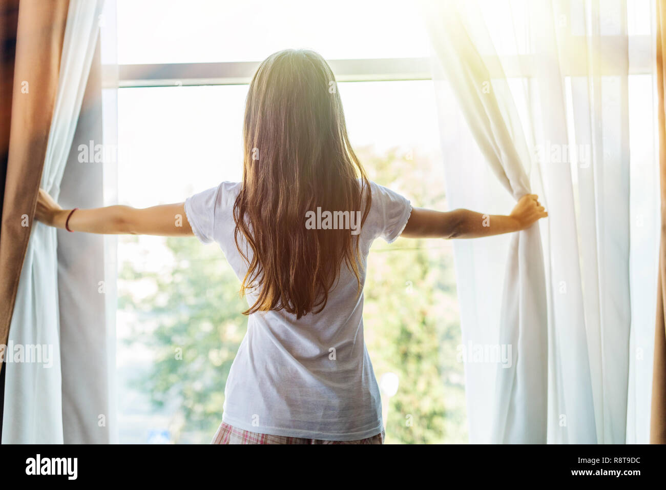 Woman, wake up and open the curtains in the morning to get fresh air ... Open Window At Morning