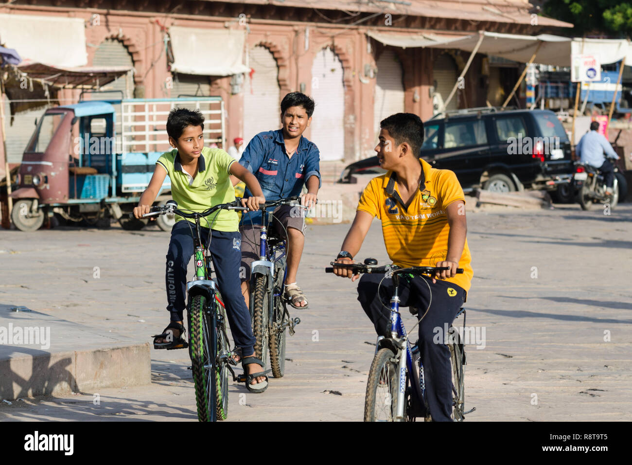 Young Indian boys riding their bikes in Jodhpur, India Stock Photo