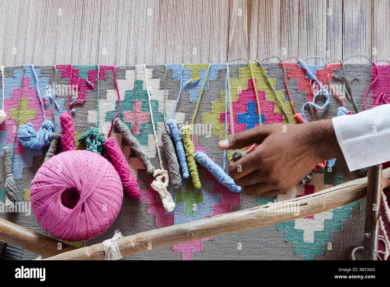 Colorful threads on a loom for traditional Panja dhurrie weaving, Salawas village, Rajasthan