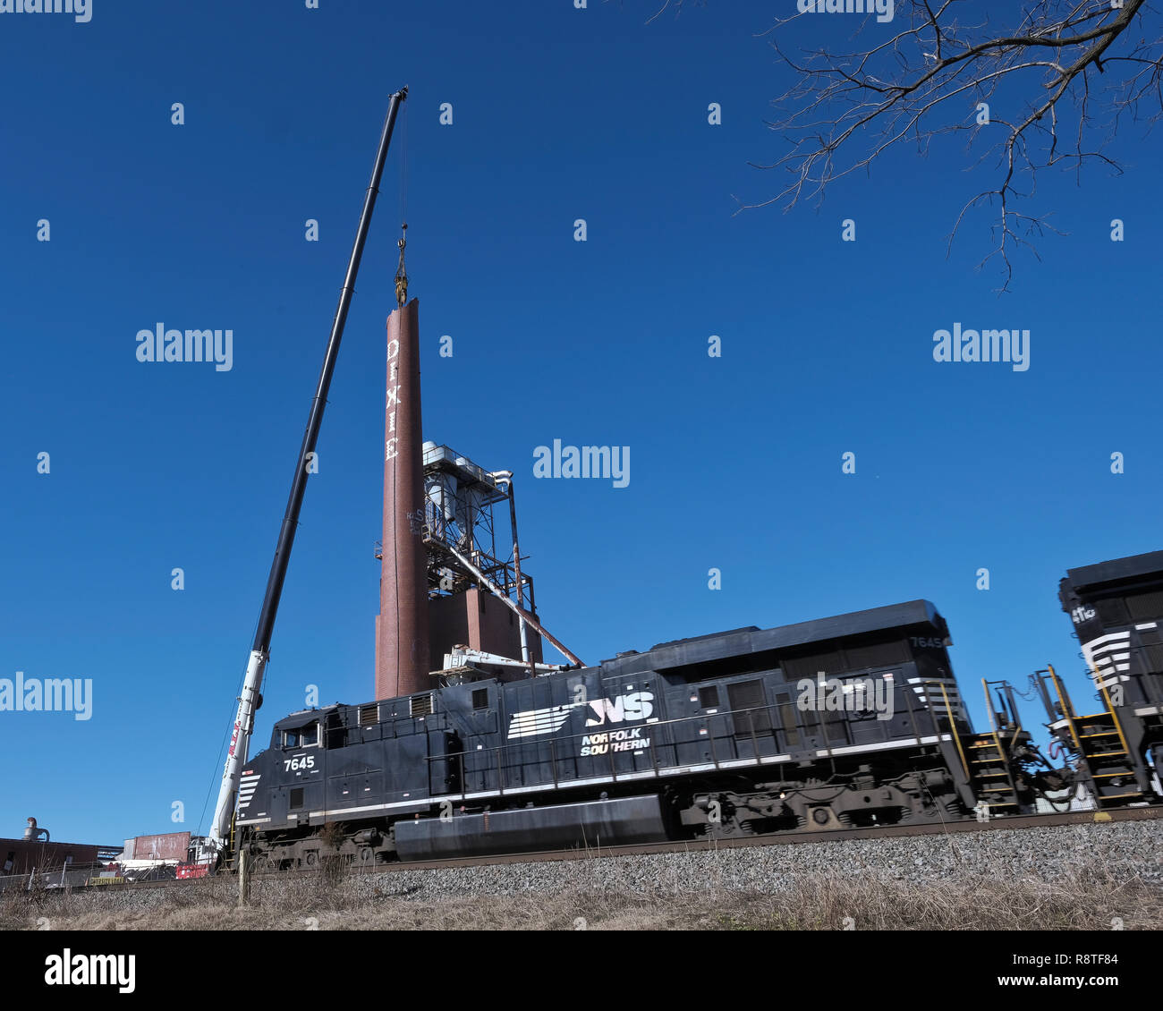 Lexington, North Carolina, USA. 17th December, 2018. Dixie Smokestack demolition. Lexington, NC. Lexington Home Brands Plant No. 1 smoke stack being domolished after fire destroyed the once prosperous manufacturing plant. The smokestack is on Norfolk-Southern right-of-way.  The smokestak was a landmark and reminder to a once thriving furniture industry in the area and it was not practical to preserve. Credit: Patrick Lynch/Alamy Live News Stock Photo