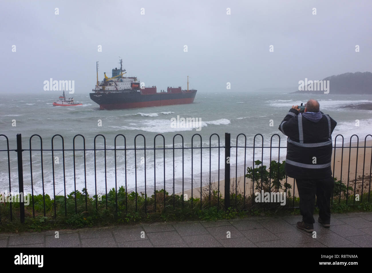 Falmouth, Cornwall, UK. 18th Dec, 2018. The Kuzma Minin bulk carrier ship sits aground on Gyllyngvase Beach with 18 Russian crew members on board waiting for a rescue from the Coast Guard. Strong winds blew the vessel aground at approximately 5:40am. Credit: Stephen Parker/Alamy Live News Stock Photo