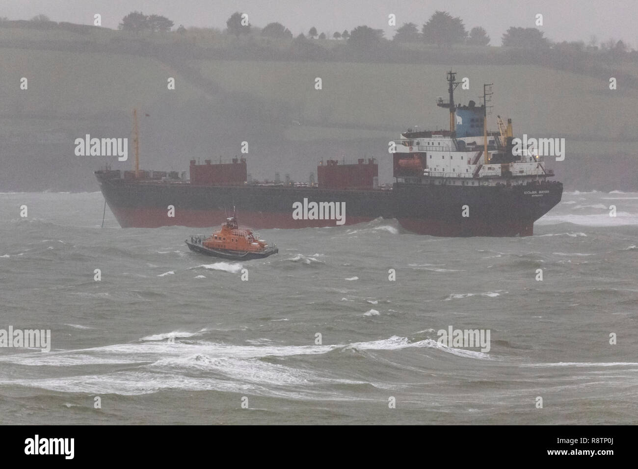 Falmouth, Cornwall, UK. 18th Dec, 2018. A rescue operation is under way after a 16,000-tonne Russian cargo ship the Kuzma Minin ran aground off Gyngvase beach in Cornwall in the early hours of the morning of Tuesday 18th December . The coastguard believes that strong gale force winds overnight caused the ship to drag its anchor and become stranded on the beach despite all te efforts of the crew. Locals have been warned to keep off the beach as rescuers attempt to re-float the vessel. Credit: Roger Hollingsworth/Alamy Live News Stock Photo