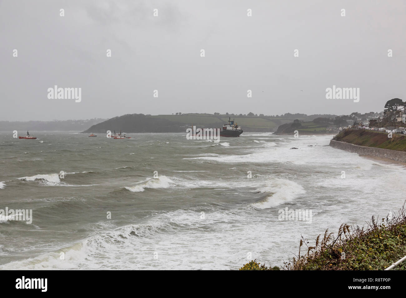 Falmouth, Cornwall, UK. 18th Dec, 2018. A rescue operation is under way after a 16,000-tonne Russian cargo ship the Kuzma Minin ran aground off Gyngvase beach in Cornwall in the early hours of the morning of Tuesday 18th December . The coastguard believes that strong gale force winds overnight caused the ship to drag its anchor and become stranded on the beach despite all te efforts of the crew. Locals have been warned to keep off the beach as rescuers attempt to re-float the vessel. Credit: Roger Hollingsworth/Alamy Live News Stock Photo