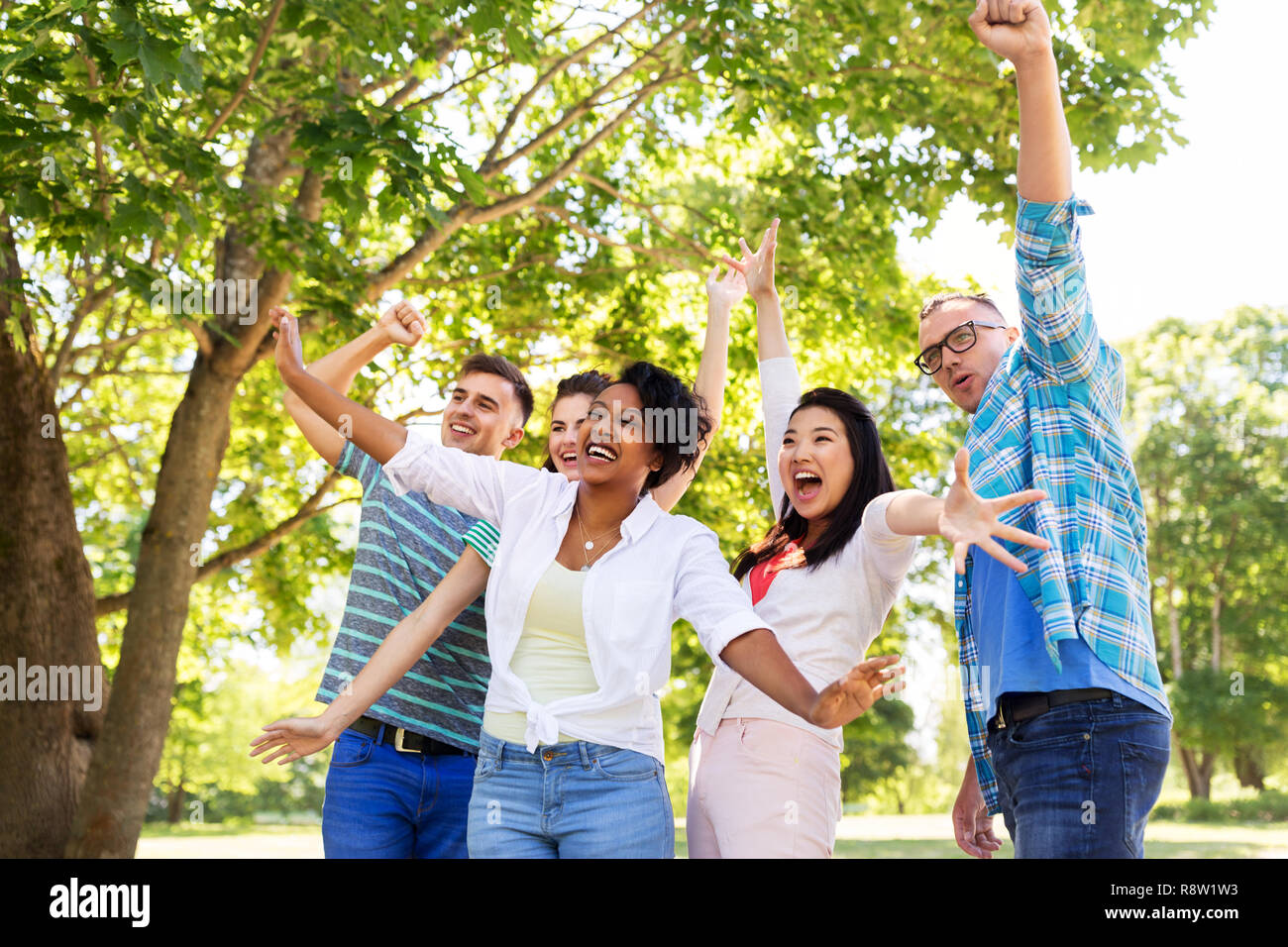 group of happy smiling friends having fun outdoors Stock Photo