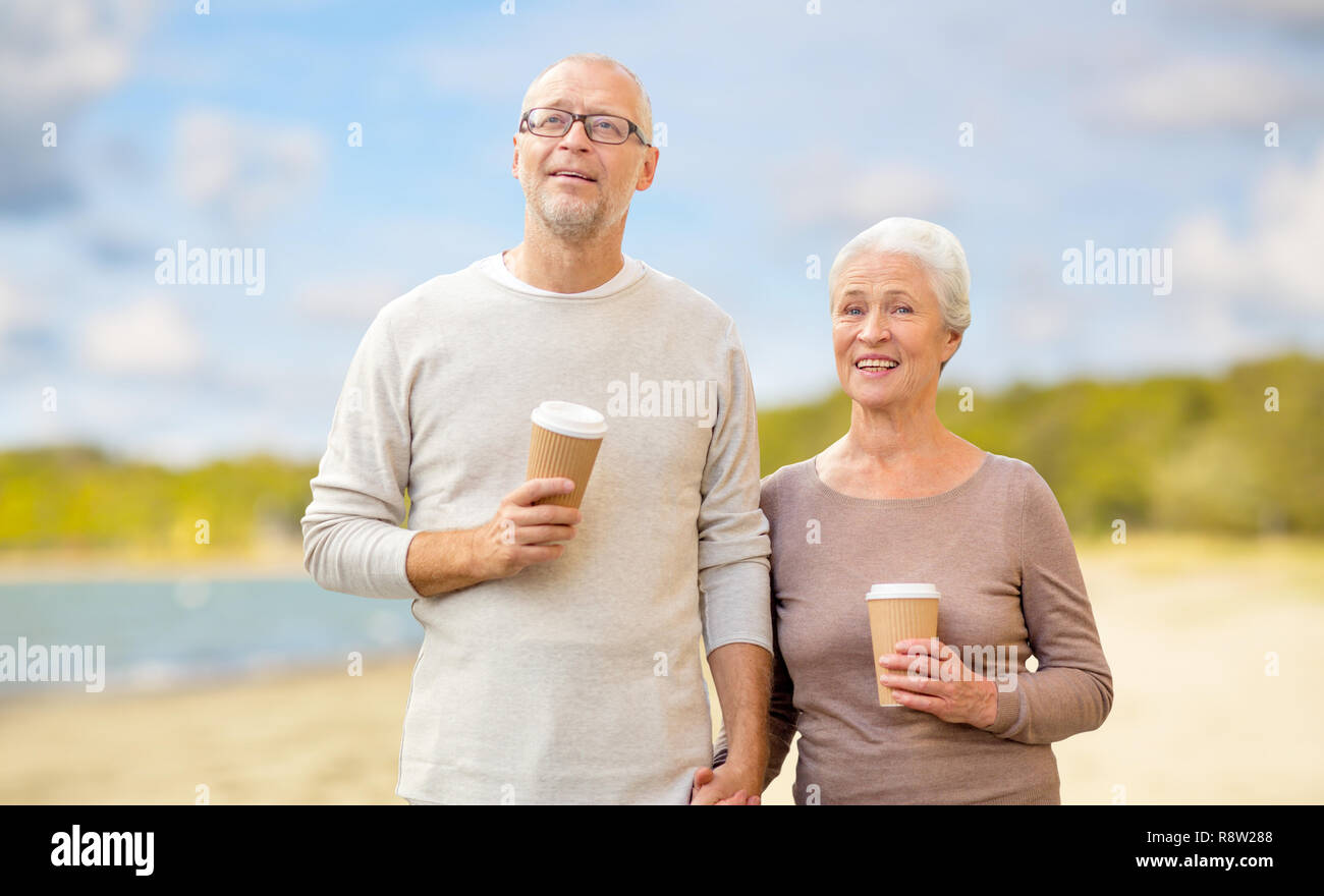 senior couple with takeaway coffee on beach Stock Photo - Alamy